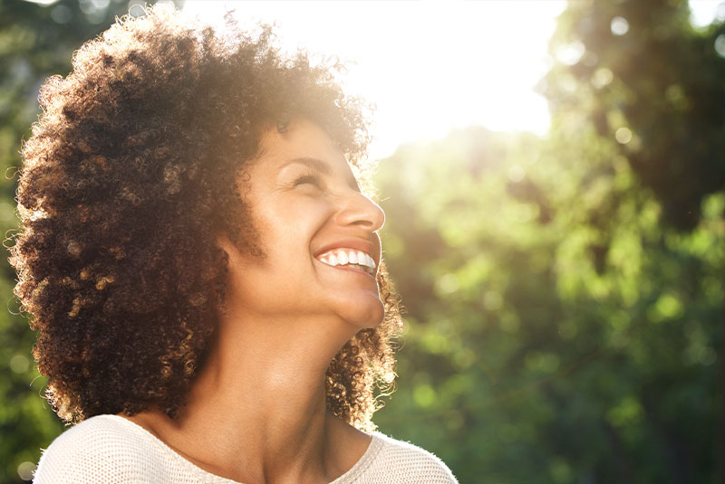 female patient smiling after their dental procedure